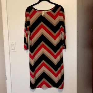 Knee length red, black, cream, and nude dress